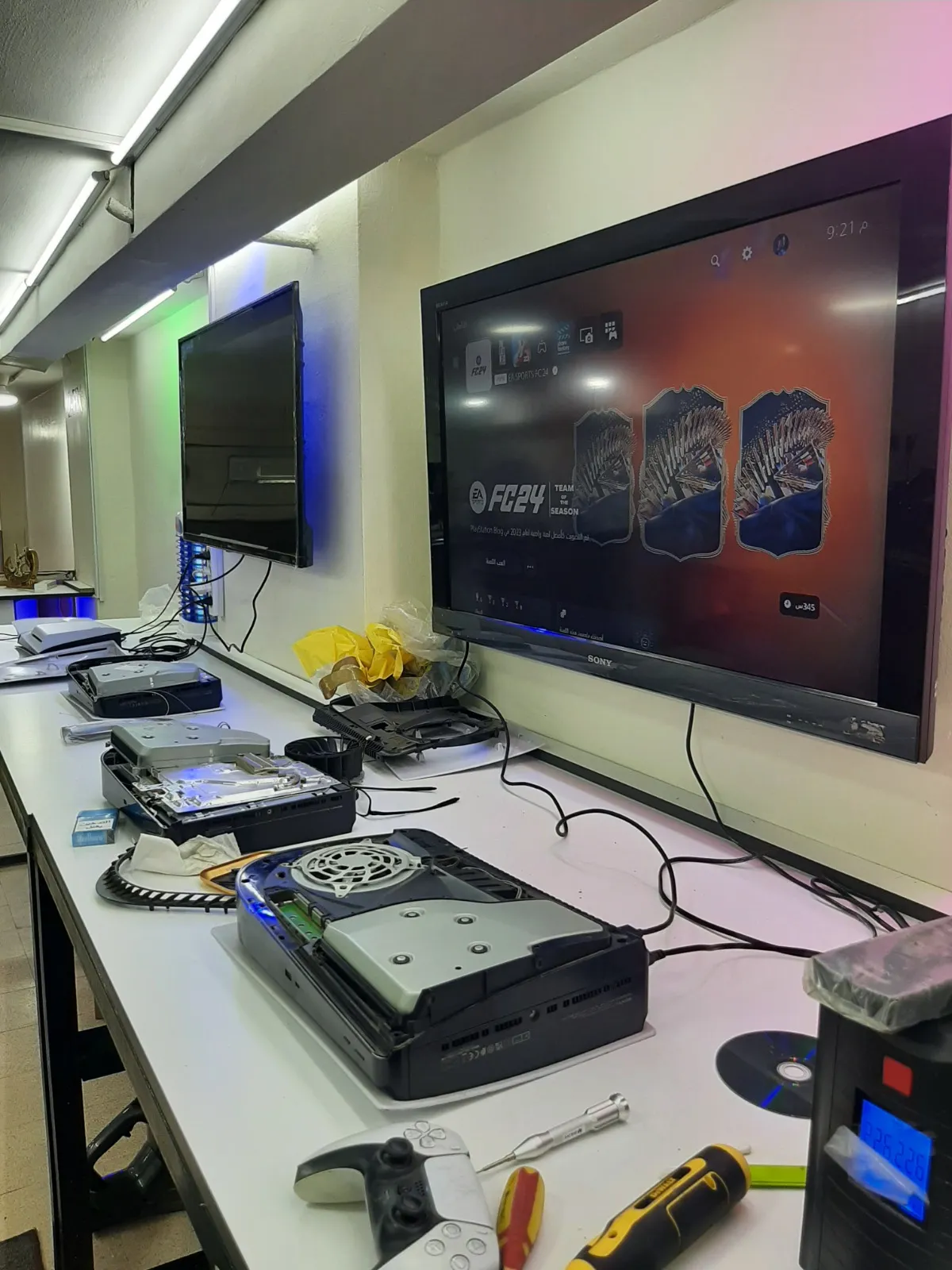 Multiple PlayStation consoles opened, connected and running on screens at the Z-Fix testing bench